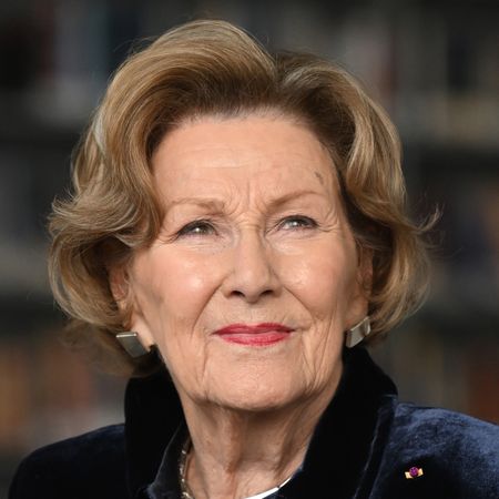 A headshot of Queen Sonja in a navy jacket