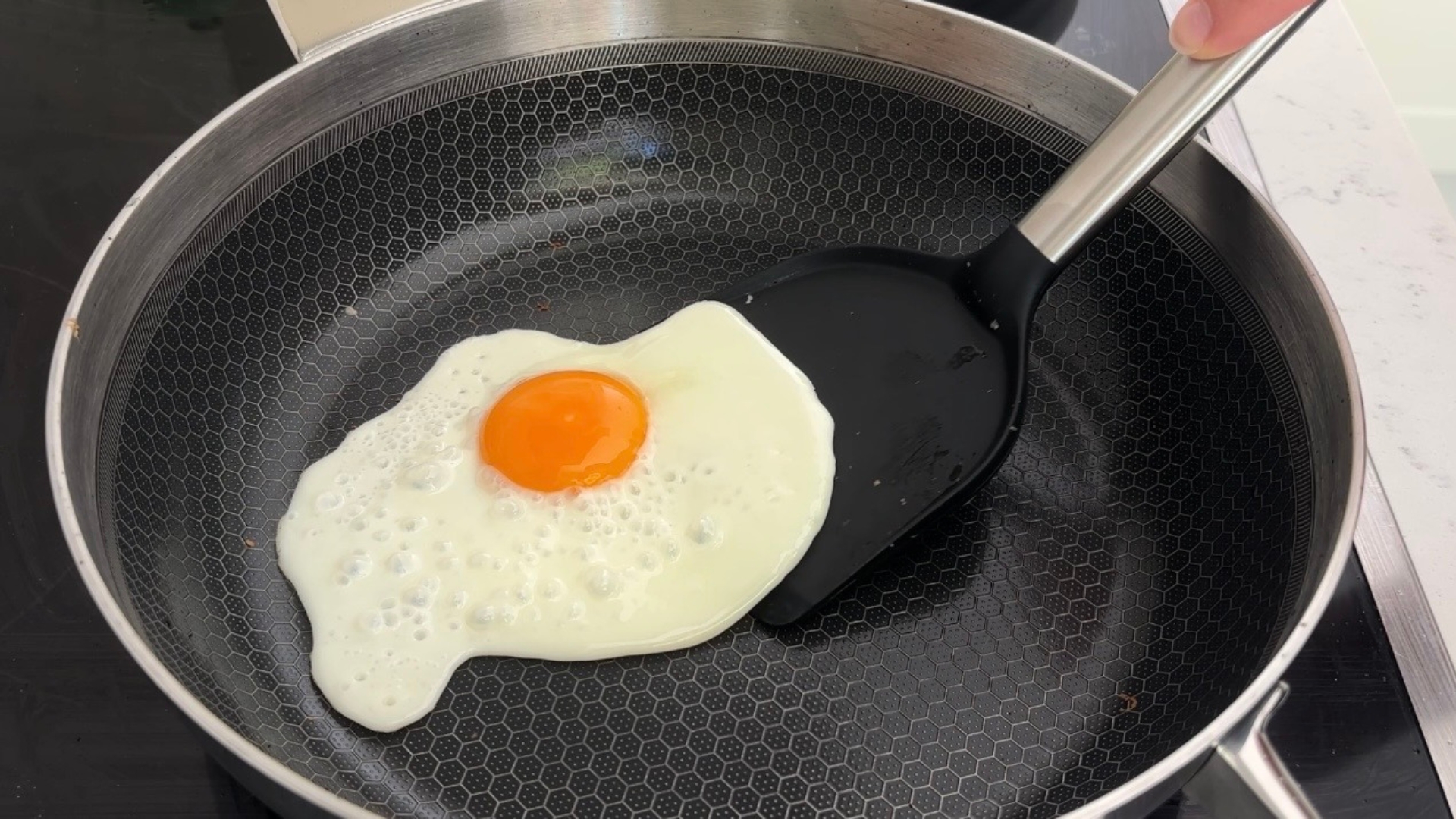 Testing the Lakeland 10-in-1 Only Pan Pro showing a fried egg