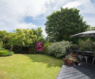 A sunny backyard with shaded terrace