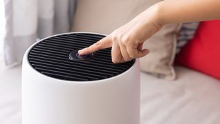 person turning on a dehumidifier