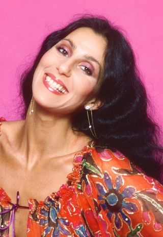Singer and actress Cher poses for a photo session in a Bob Mackie blouse on March 21, 1977 in Los Angeles, California