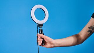 The Neewer Basics BR60 5" Ring Light photographed in front of a blue background.
