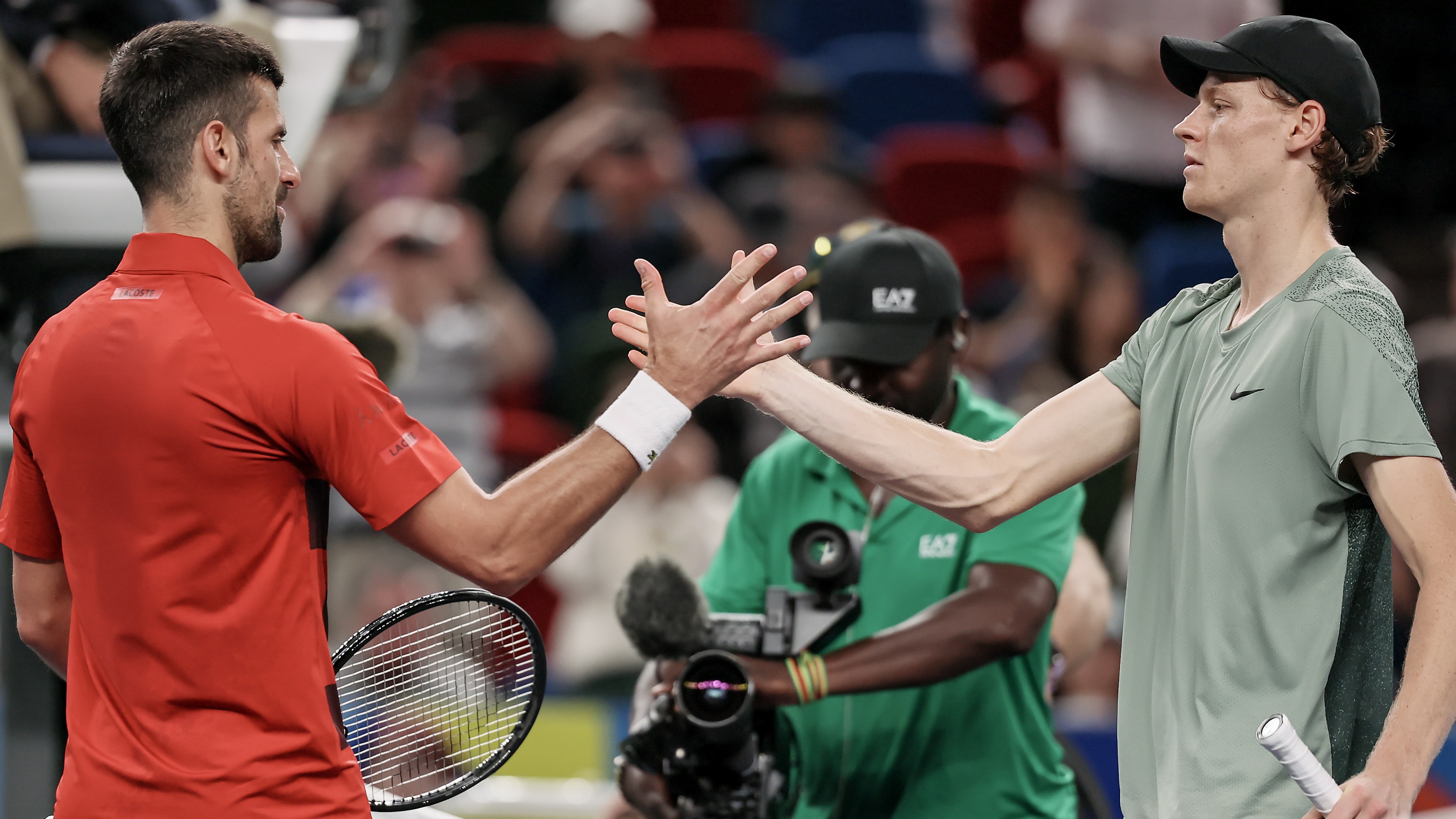Jannik Sinner and Novak Djokovic shake hands after the Chinese Open.