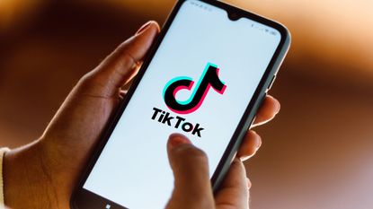  the TikTok logo seen displayed on a smartphone.