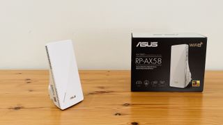 Asus RP-AX58 on a wooden table