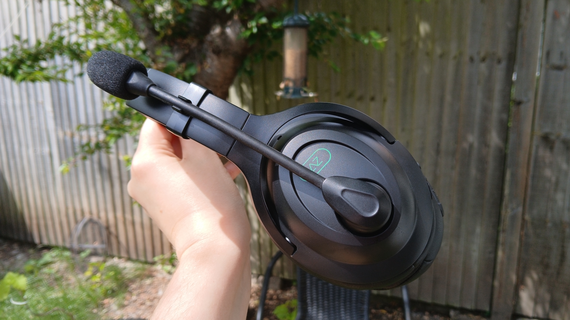 An AceZone A-Blaze wireless gaming headset held up outside.
