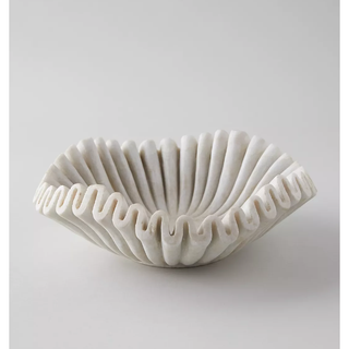 white marble bowl with exaggerated ruffle rim