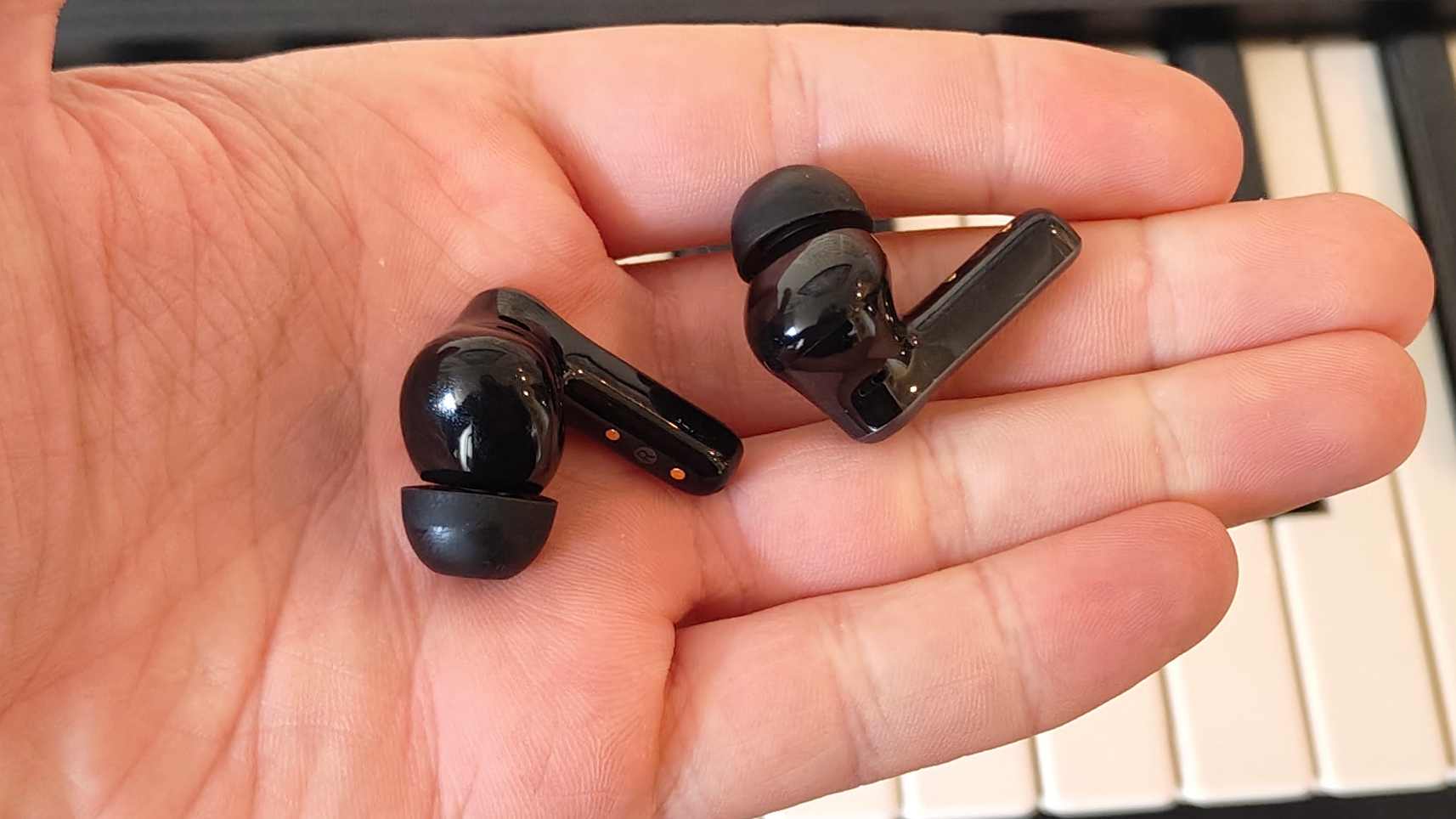 The Earfun Air Pro 4 Plus on top of a keyboard.