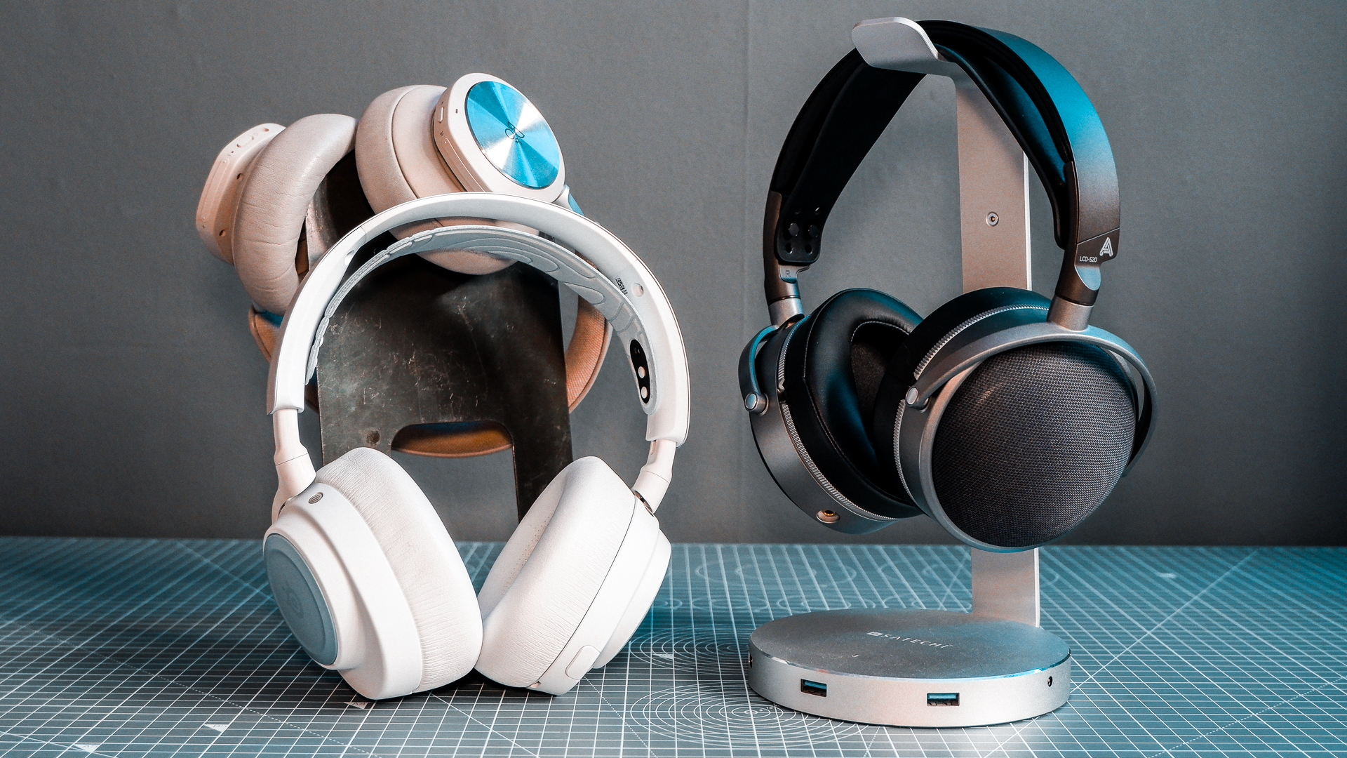 Two pairs of headphones. One, a SteelSeries set with ANC; the other, an Audeze set with great passive sound isolation.