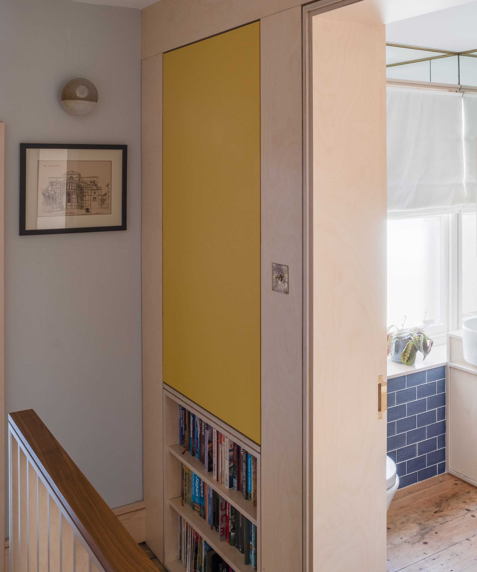 A small landing in a Victorian terrace with built in storage made of birch plywood