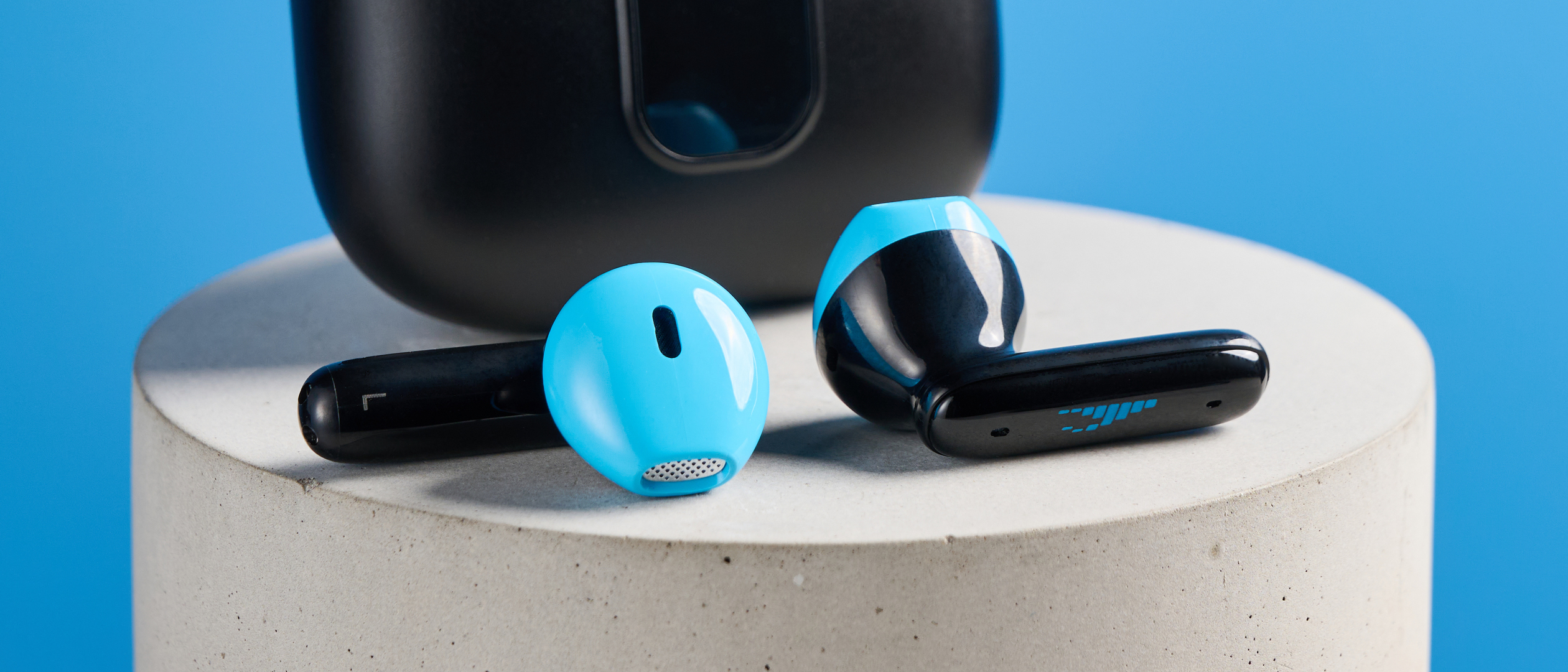 the h2o audio ript-lite earbuds in black and blue, photographed against a blue background, for both working out and everyday use