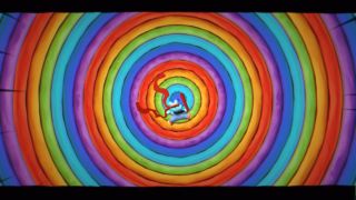 A small animal in the middle of a spiral rainbow