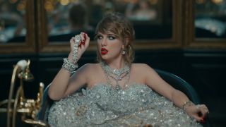 Taylor Swift sitting in a bath of diamonds in the Look What You Made Me Do music video.