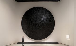 large black spherical artwork on wall