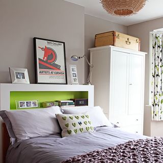 bedroom with white wardrobe and green headboard