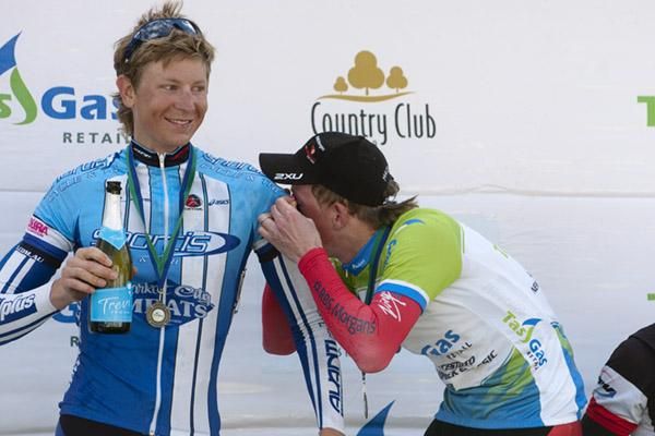 Mind if I use your top: Race winner Patrick Shaw wipes the champagne from his eyes on Chris Jory's jersey after the podium celebrations in New Norfolk.