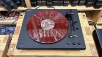 Sony PS-LX5BT turntable on wooden hi-fi rack with red vinyl on platter