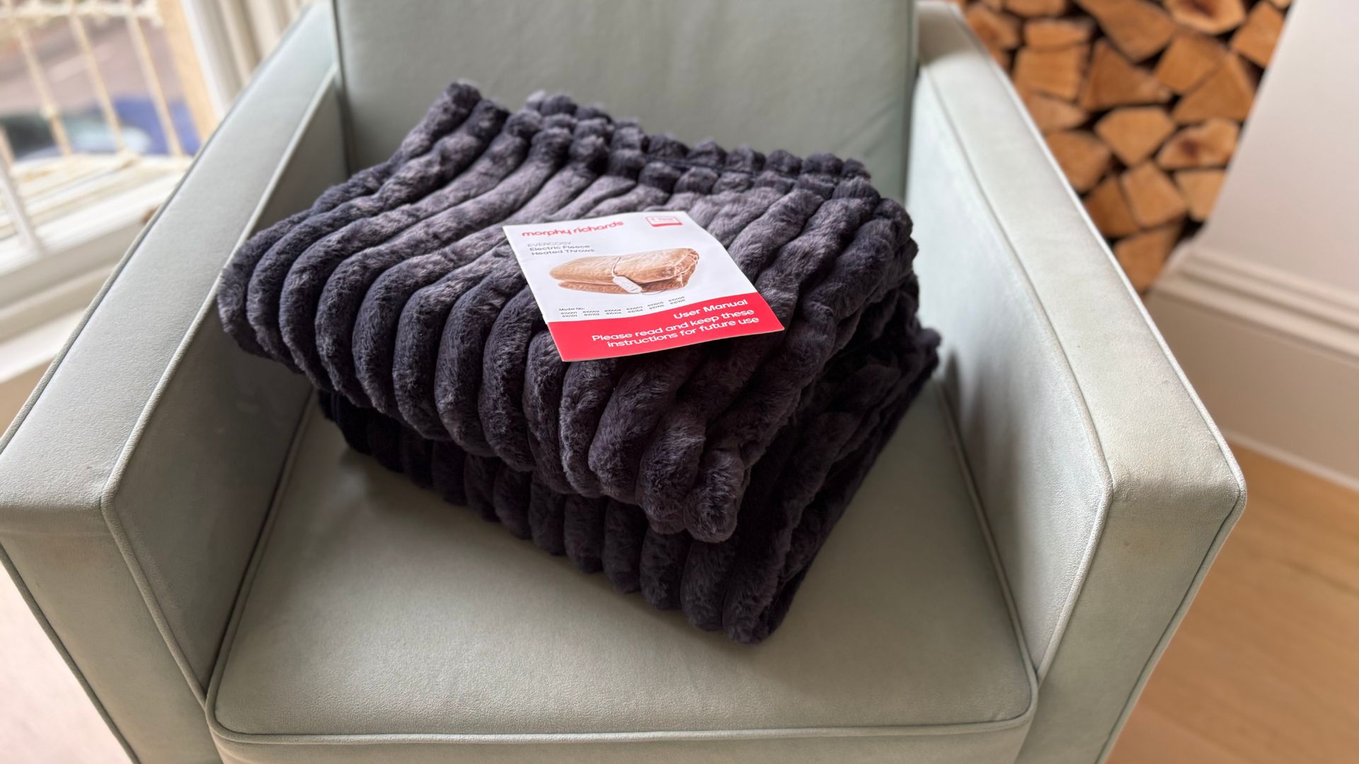 The Morphy Richards EverCosy Heated Throw on a chair, being tested for our review
