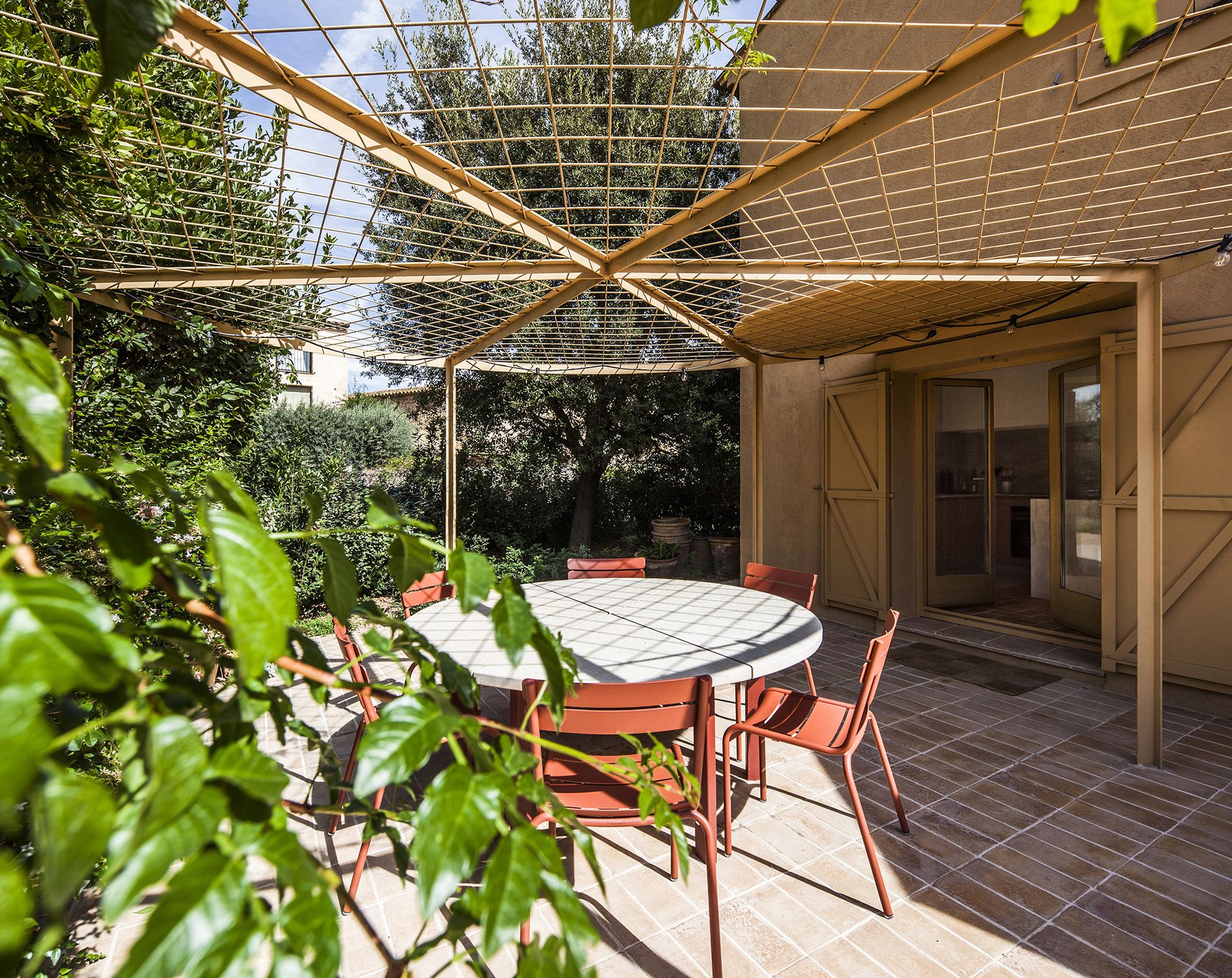A circular pergola will eventually shade the dining space outside the kitchen