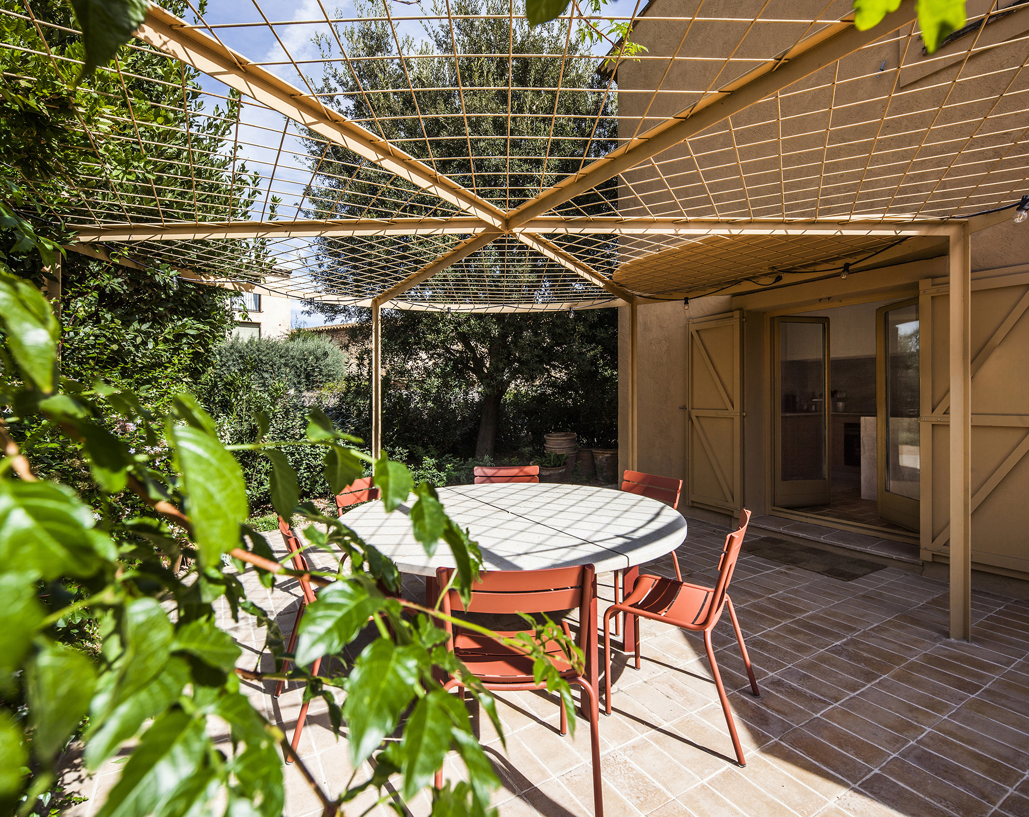 A circular pergola will eventually shade the dining space outside the kitchen