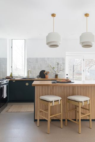 A kitchen island with pretty pendants above it