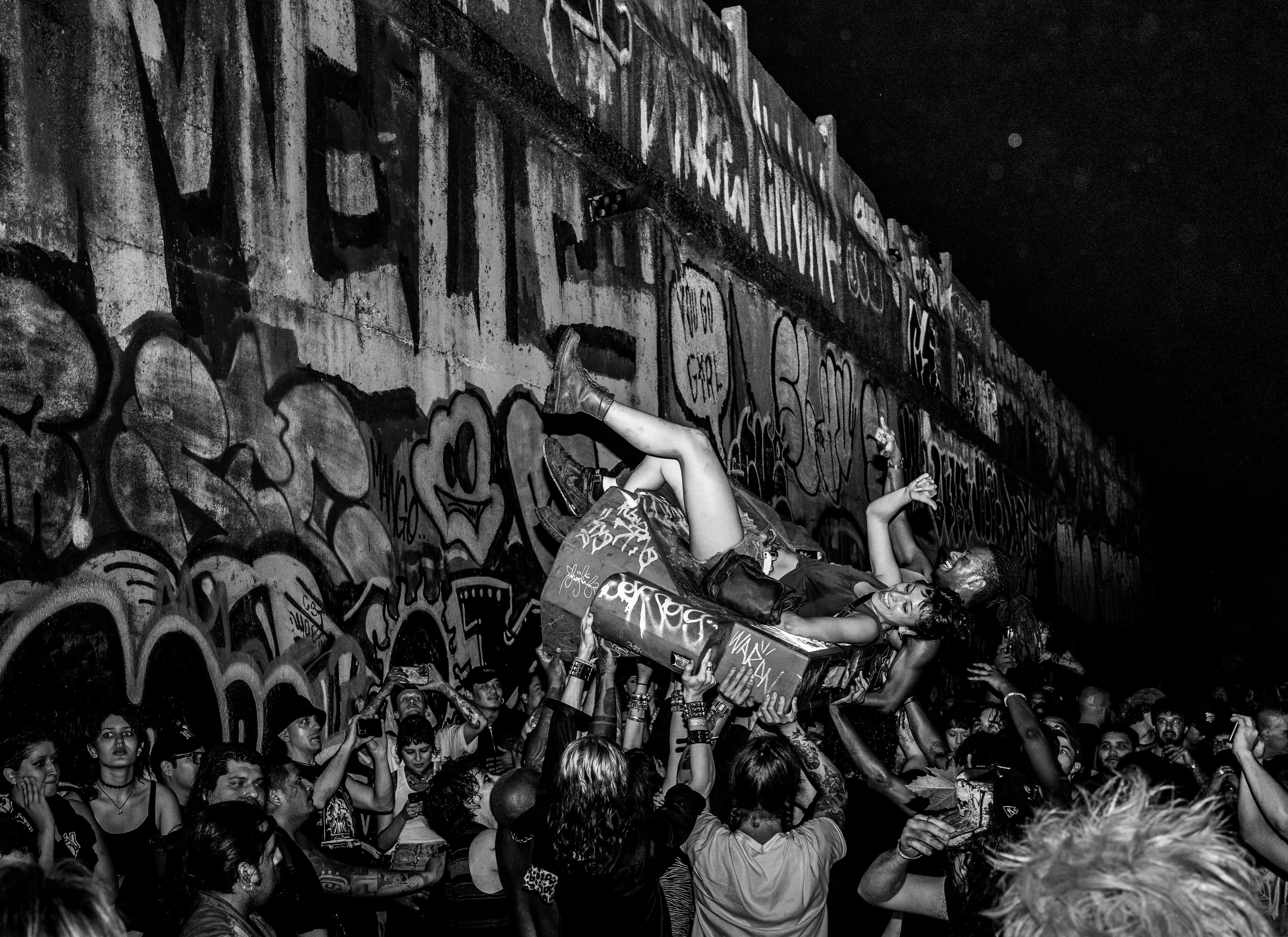 Punk rock fans crowd surfing.