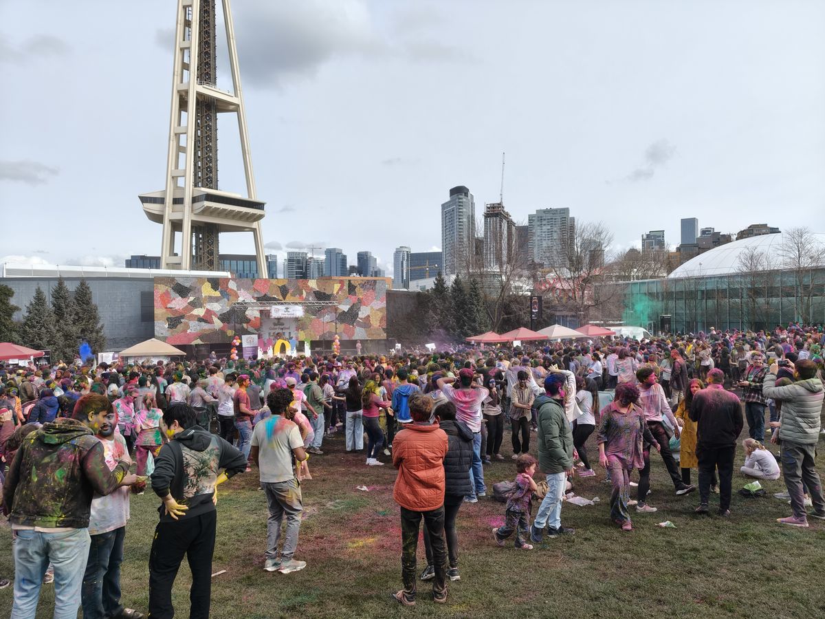 A group of people with colored powder everywhere