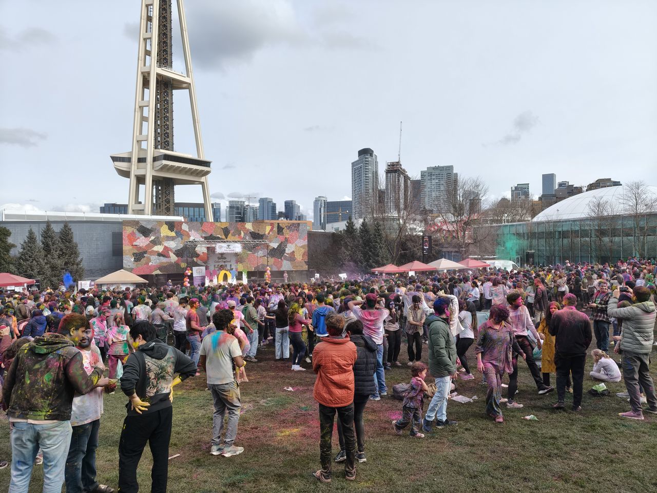 A group of people with colored powder everywhere