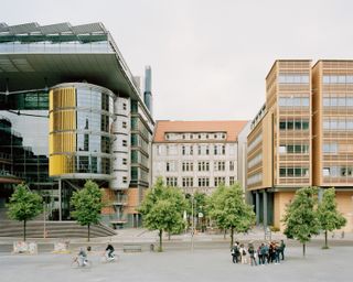 walking through Potsdamer Platz in Berlin and its postmodernist architecture, showing large scale buildings with transparencies and grids