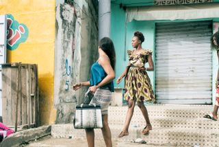 Photo of two women wearing skirts and dresses in the street