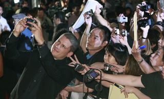 Actor Wentworth Miller takes a photo with fans during the world premiere of