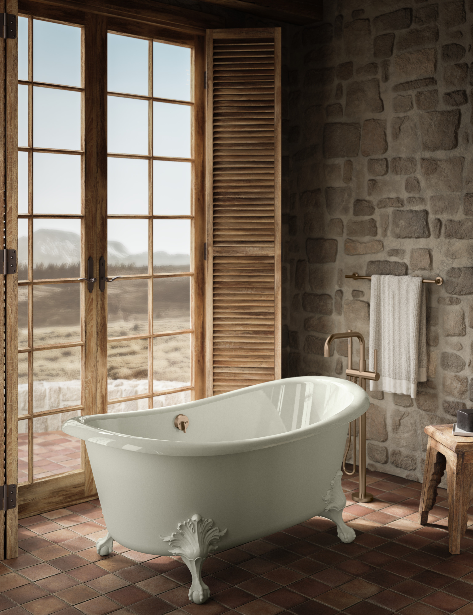 Artifacts freestanding bathtub by Kohler pictured styled with ornate legs inside of a rustic bathroom overlooking a desert scene