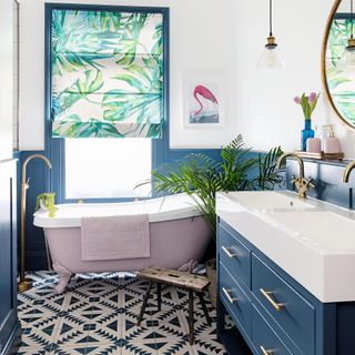 blue bathroom with pink bath and tropical blind