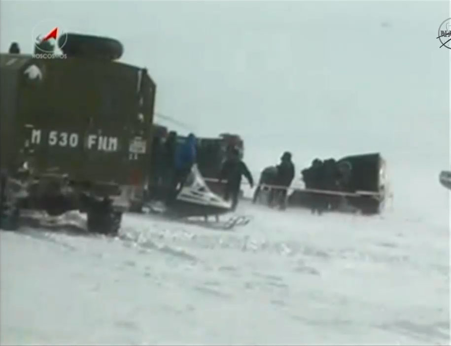 Recovery crews attend to a Russian Soyuz TMA-01M spacecraft after it landed on the snowy, windy steppes of Kazakhstan in Central Asia on March 16, 2011. The Soyuz returned NASA astronaut Scott Kelly and Russian cosmonauts Oleg Skripochka and Alexander Kal