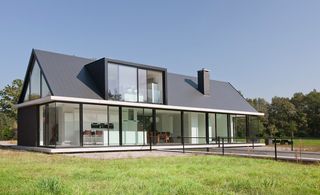 Set in the Dutch countryside, the house is located at the rear of a large flat site