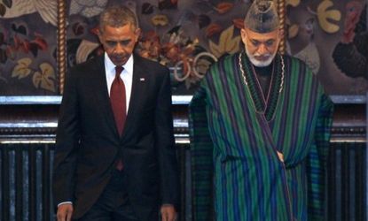 President Obama and Afghan President Hamid Karzai greet the press before signing a strategic partnership agreement at the presidential palace in Kabul Wednesday. 