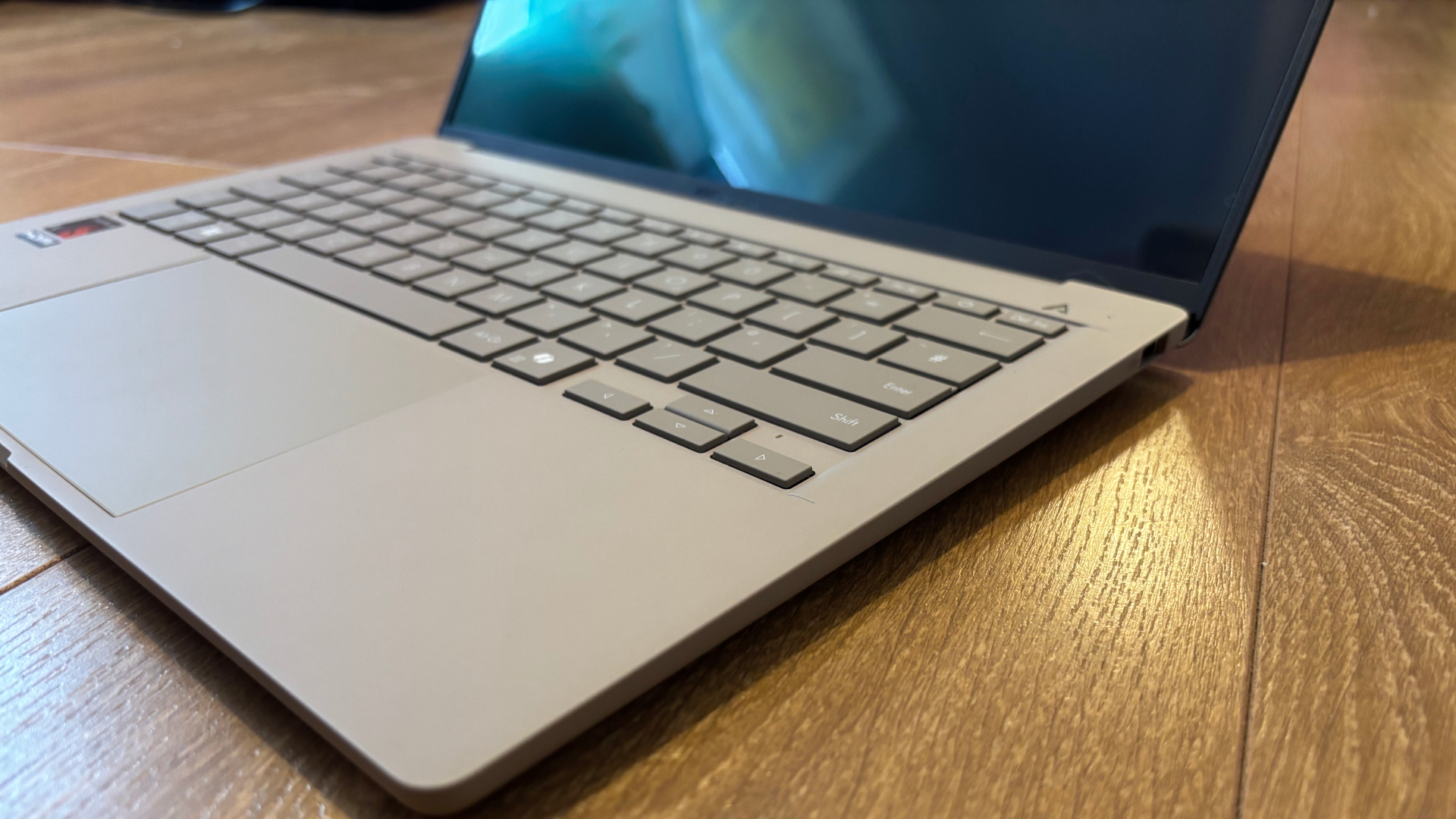 Asus Zenbook A14 laptop resting on the floor