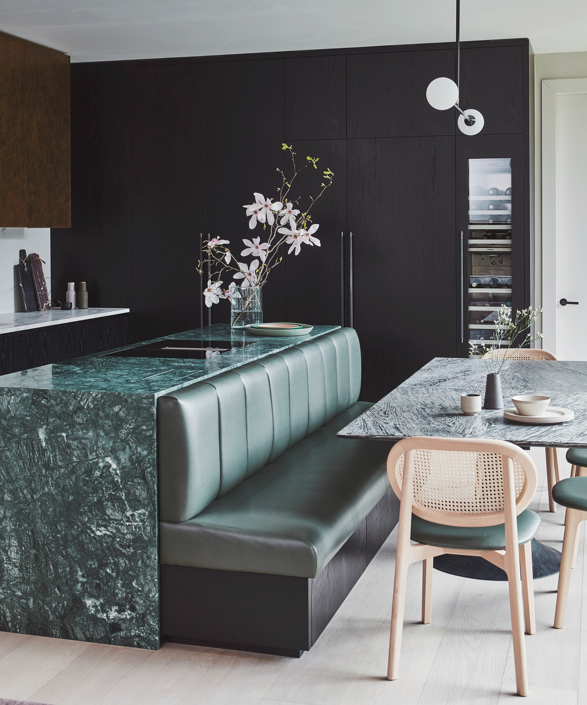 Green marble kitchen island with green leather banquette