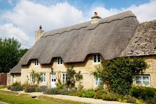 Thatched roof home with slate roof extension
