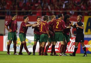 Portugal players argue with the referee after Joao Pinto (number 8) is sent off against South Korea at the 2002 World Cup.