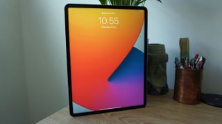 An iPad Pro 12.9 (2021) stood on a table in portrait orientation