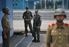 South and North Korean soldiers guard the DMZ.