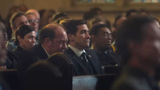 Bill Camp's Raymond and Jake Gyllenhaal's Rusty are shown at a funeral on Presumed Innocent.