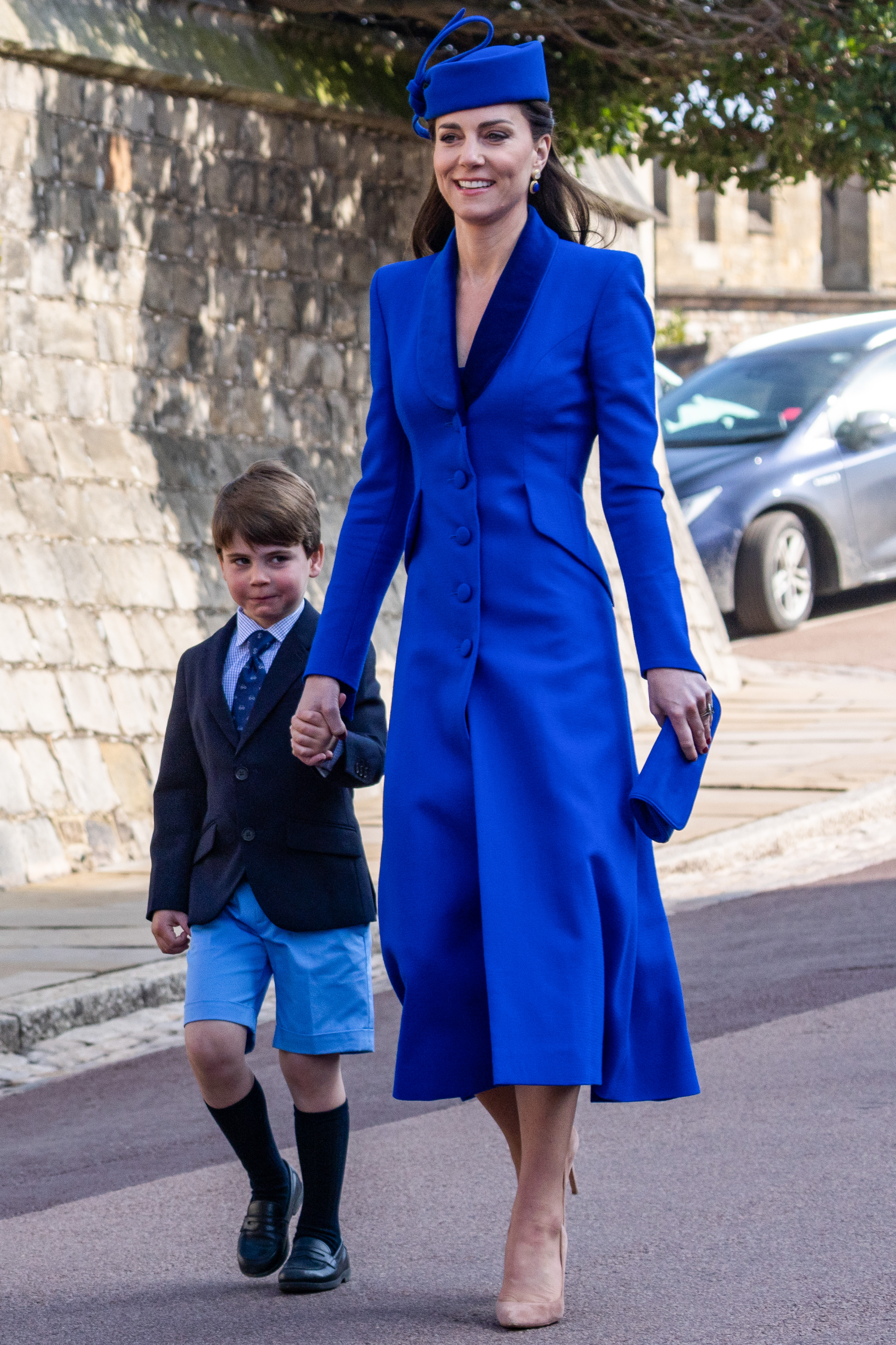 Princess Kate holding hands with Prince Louis wearing a cobalt coat