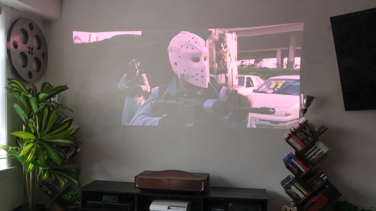 The Hisense L9Q UST projector in a living room