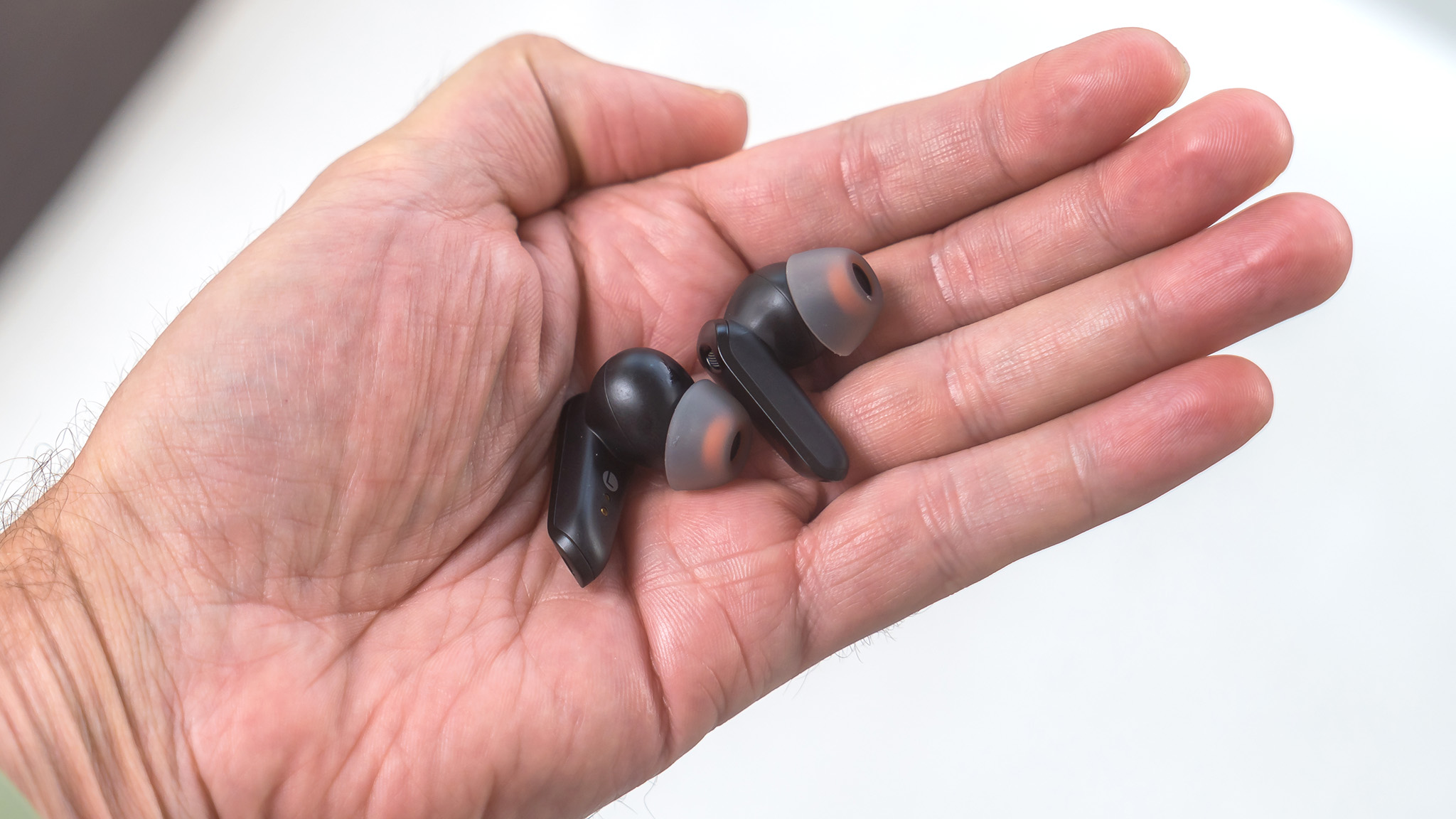 Edifier NeoBuds S earbuds in hand.
