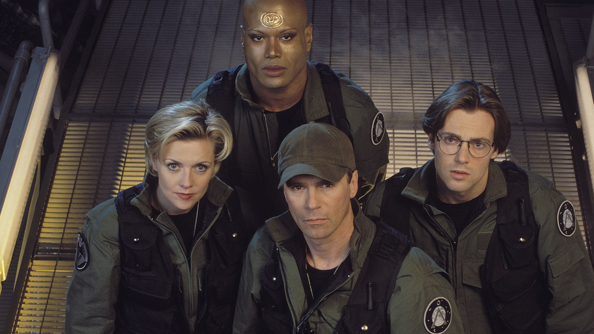 Richard Dean Anderson as Jack O'Neill, Michael Shanks as Daniel Jackson, Amanda Tapping as Samantha Carter, and Christopher Judge as Teal'c during SG-1.