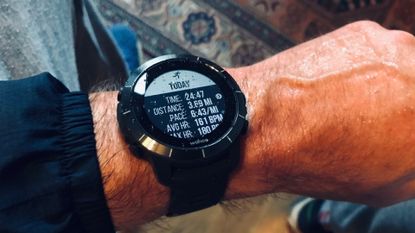 Male cyclist wearing the Wahoo Elmnt Rival smartwatch for cycling