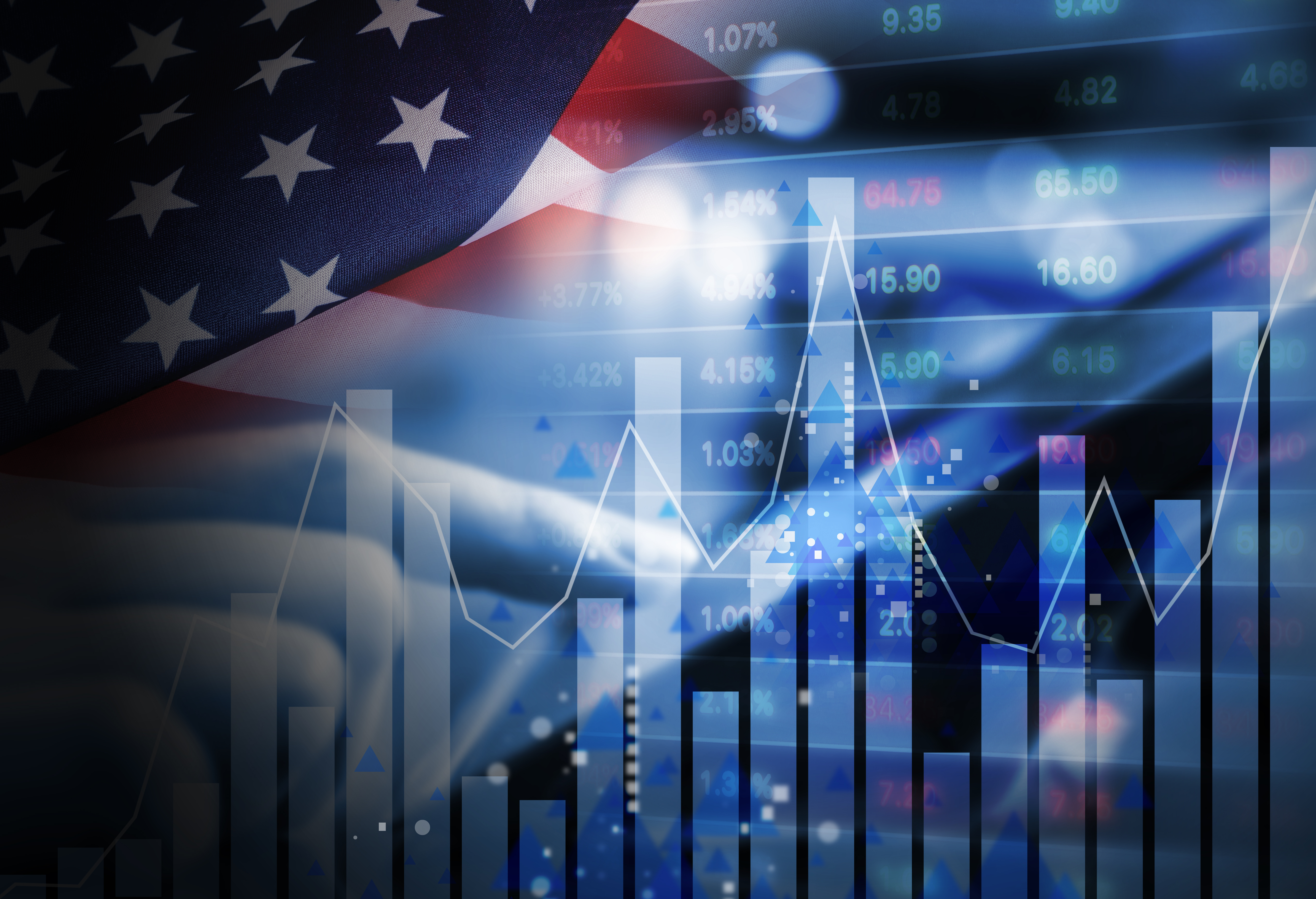 An investor using a tablet double exposed against US flag and stock market indicators