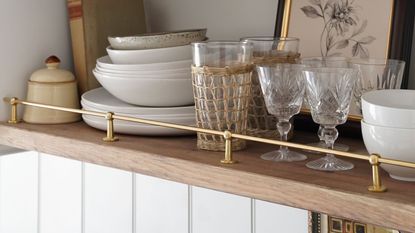 Kitchen shelves with a brass riser rail